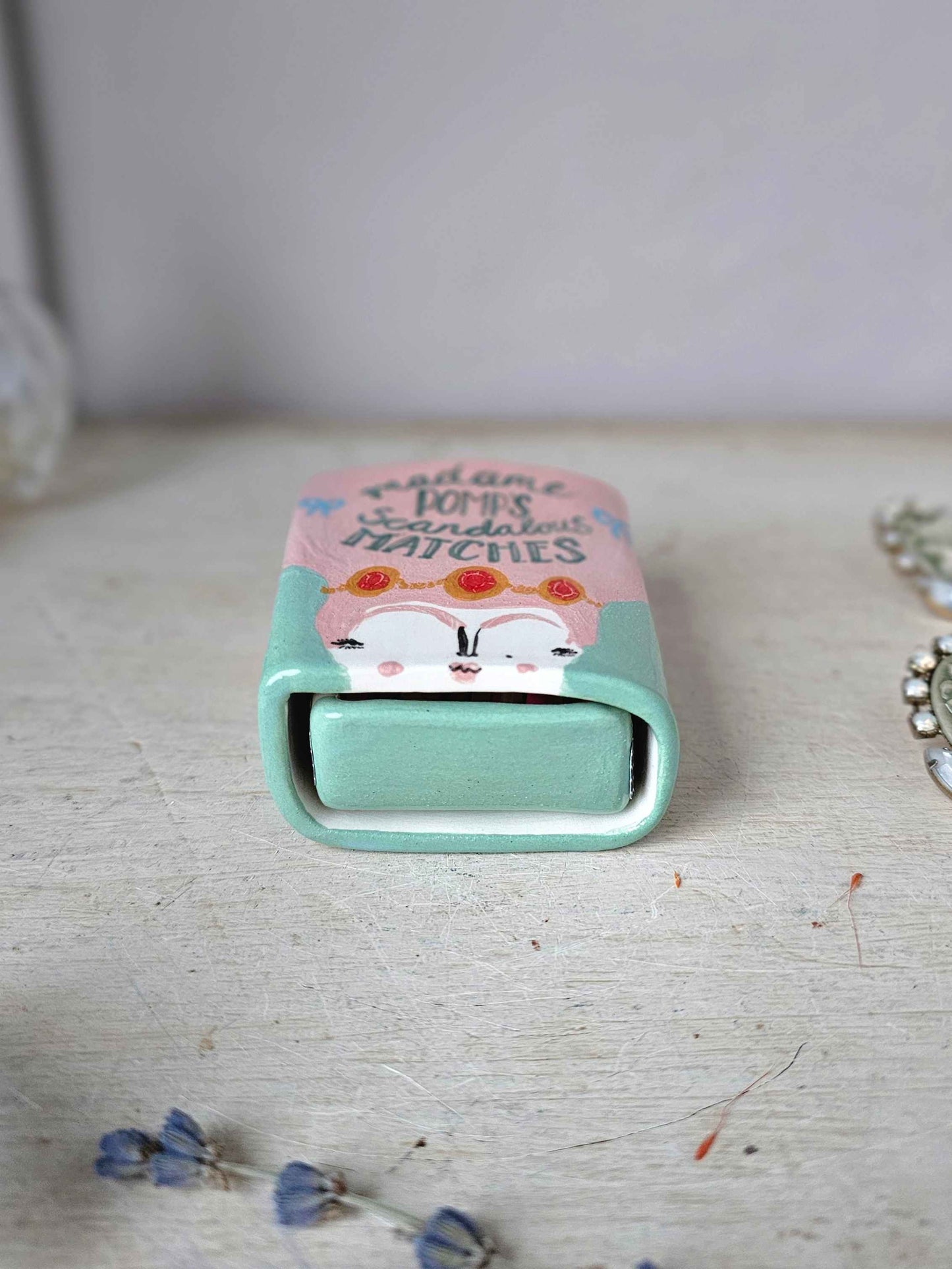 Madame Pomp's Scandalous matches small ceramic matchbox
