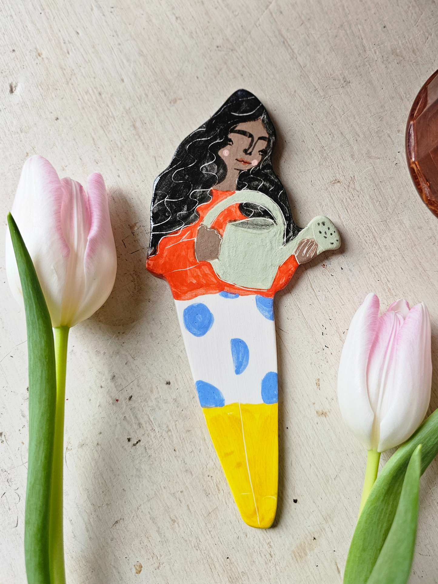 Yolanda watering ceramic plant friend marker