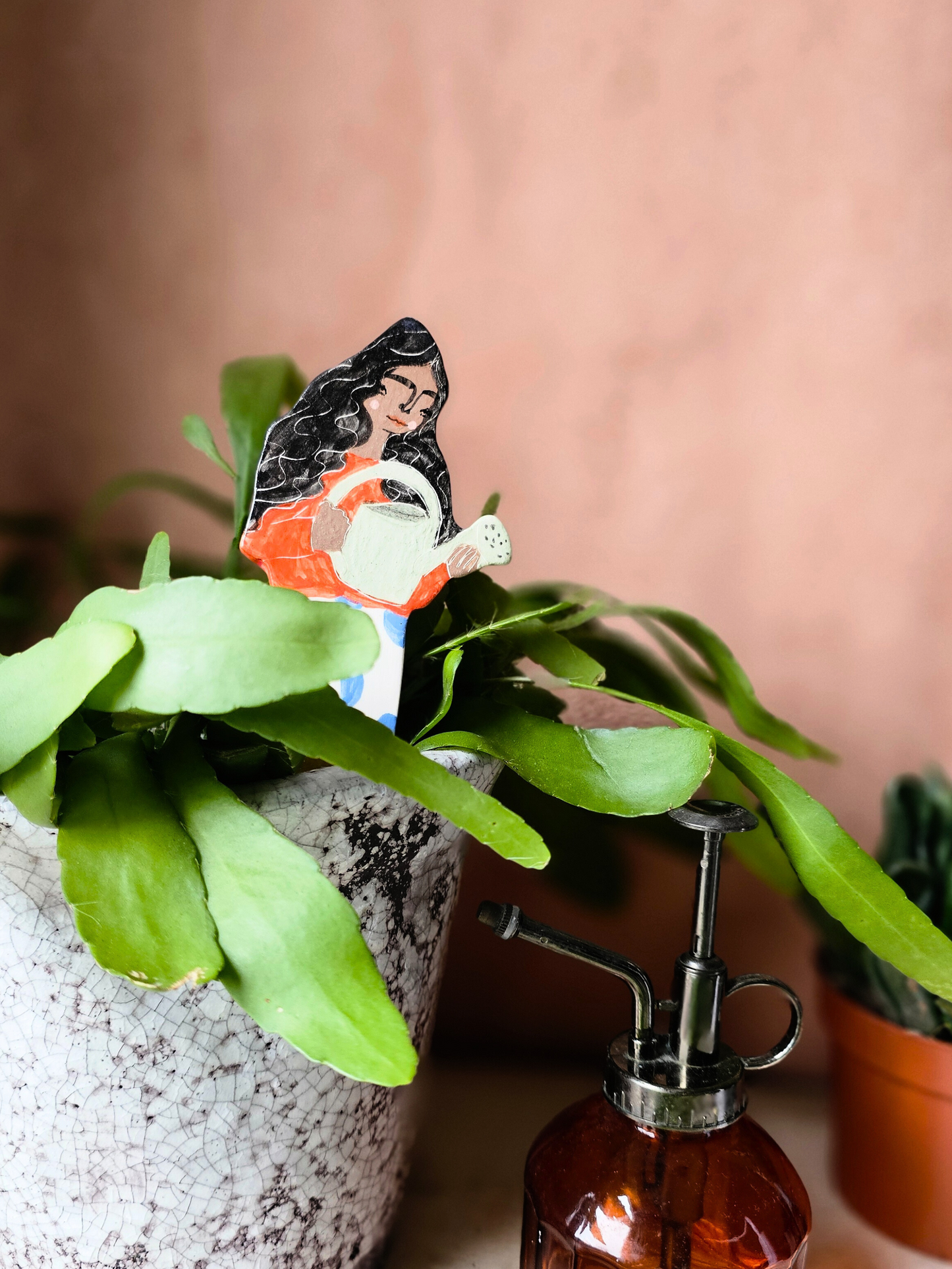 Yolanda watering ceramic plant friend marker