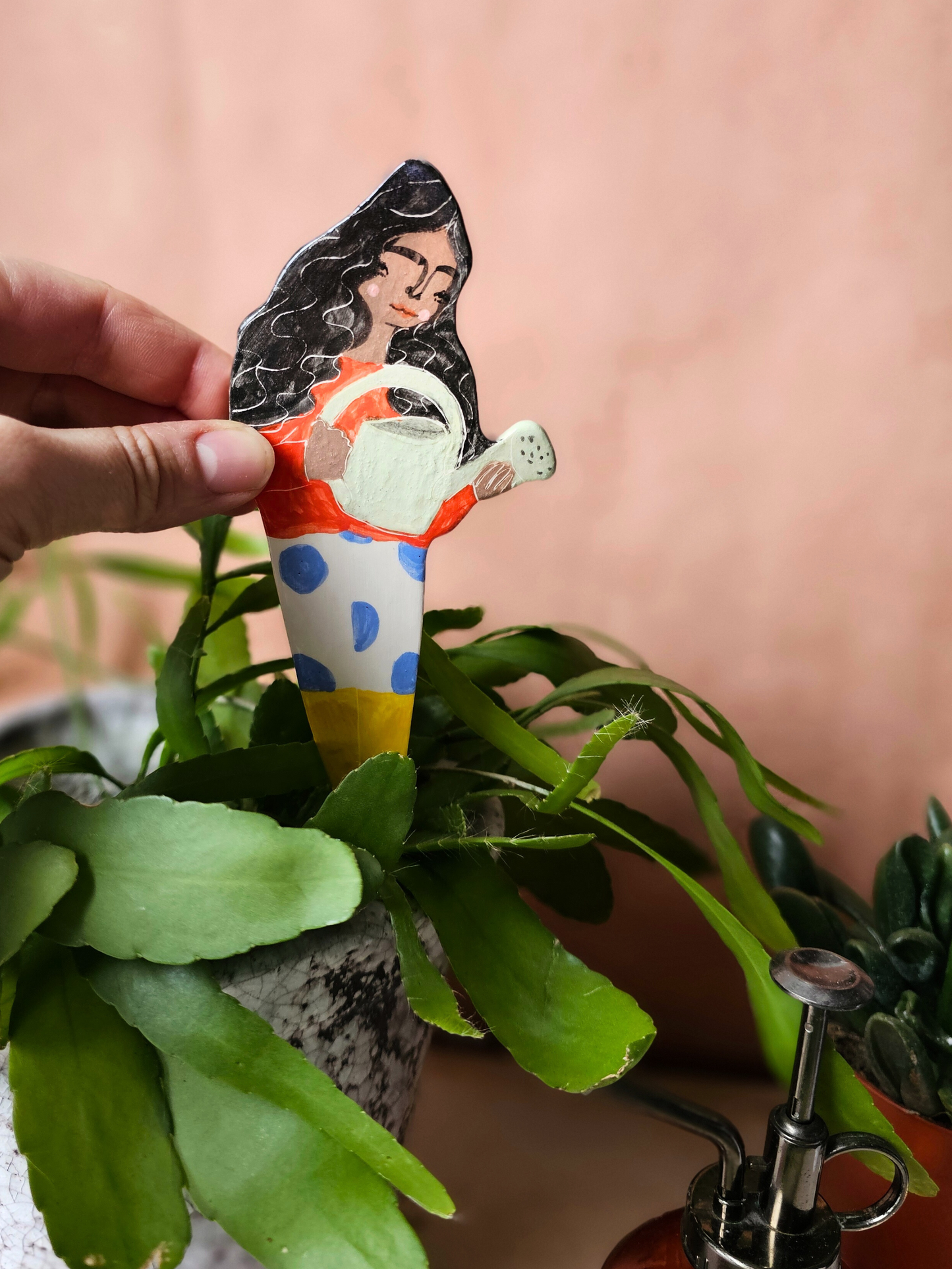 Yolanda watering ceramic plant friend marker