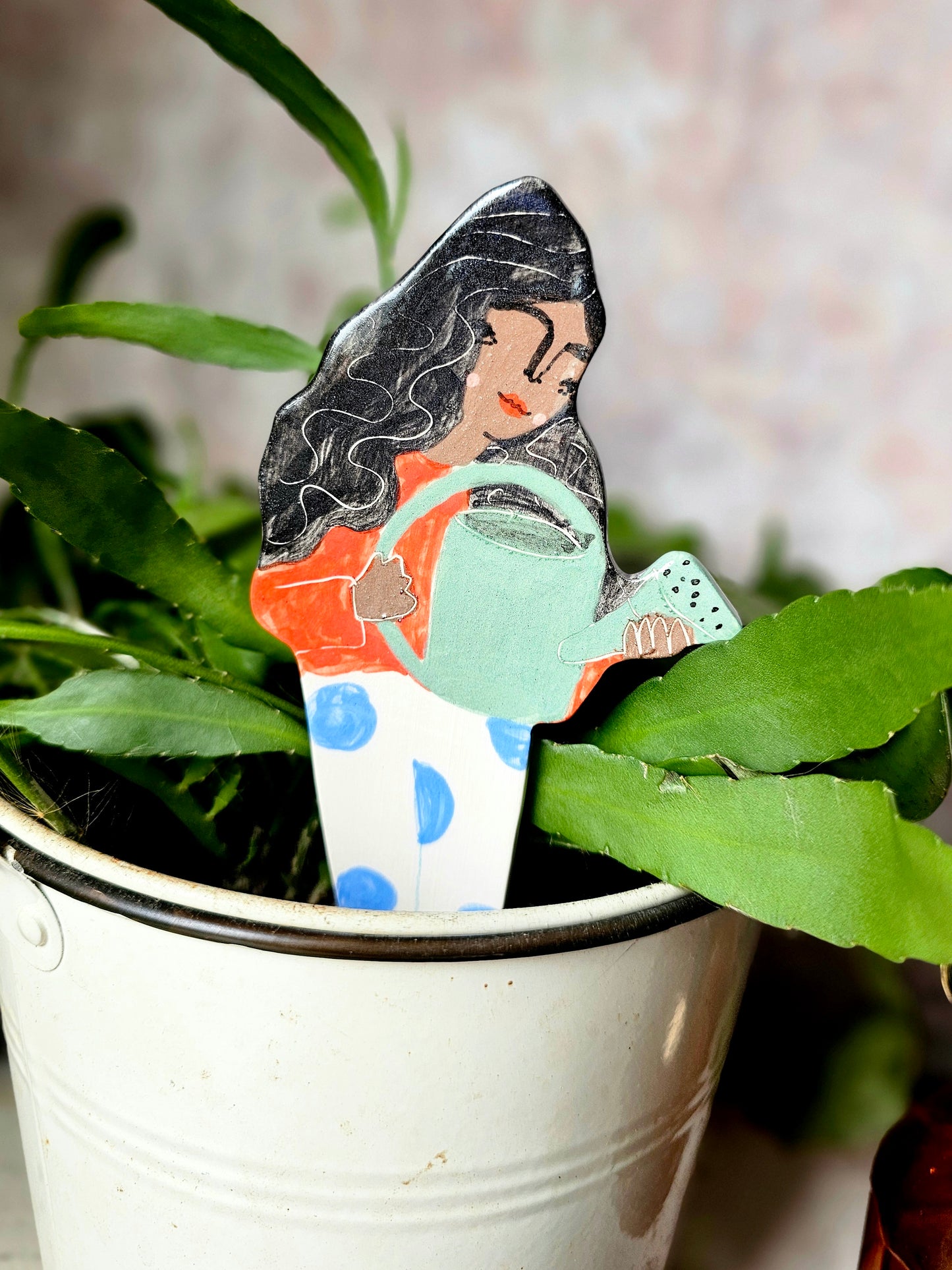 Yolanda watering ceramic plant friend marker