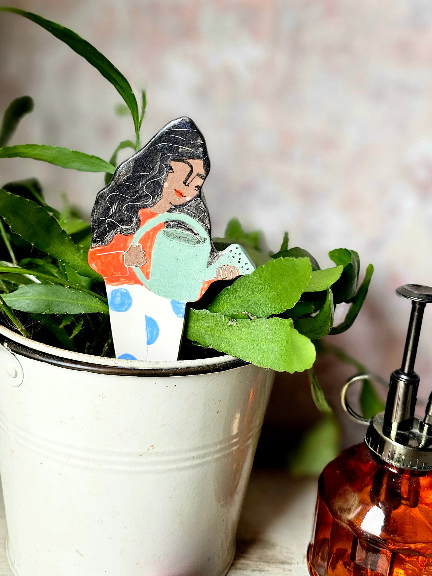 Yolanda watering ceramic plant friend marker