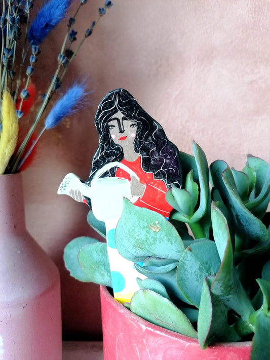 Yolanda watering ceramic plant friend marker