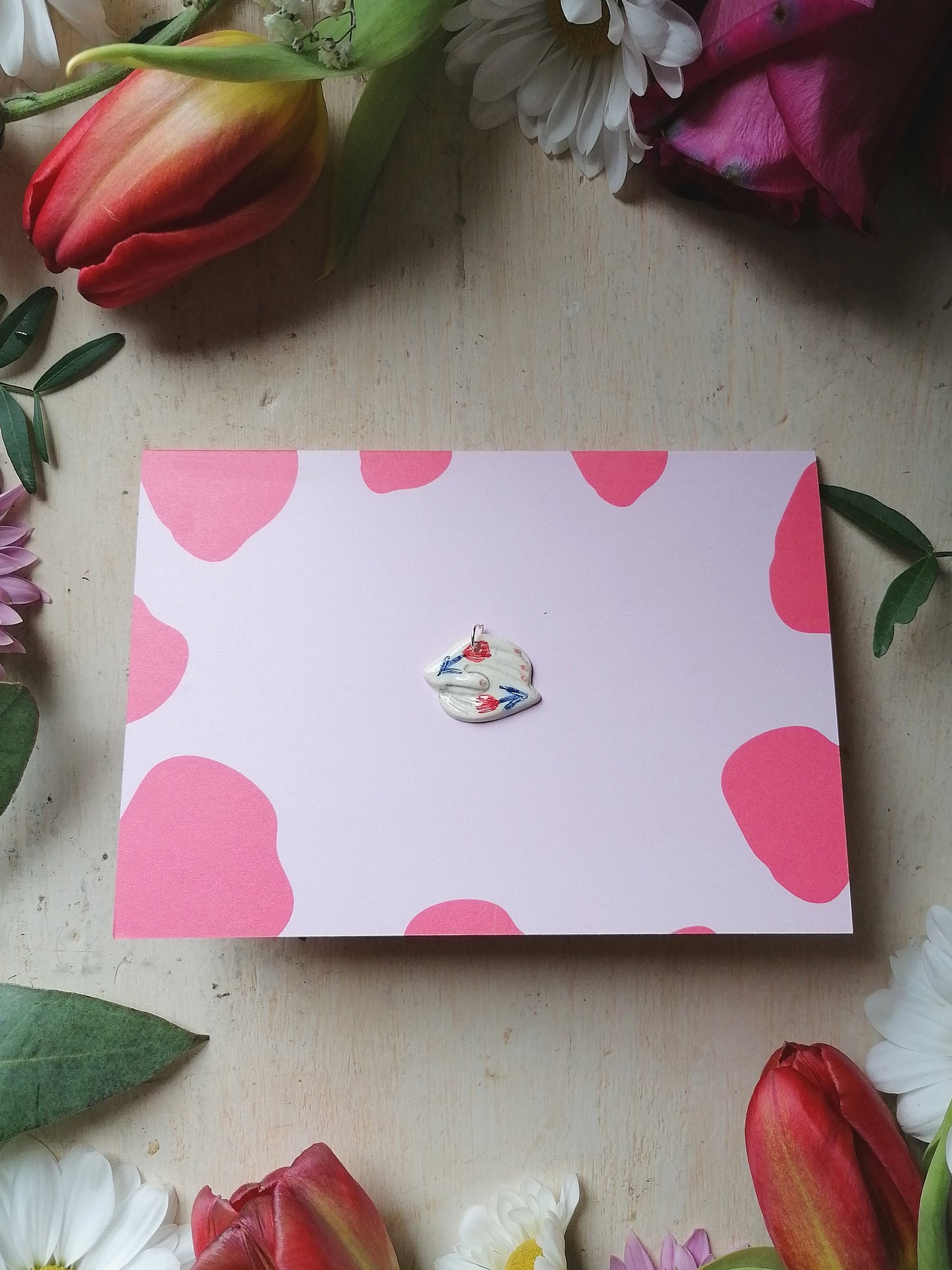 Holding hands card with ceramic pendant